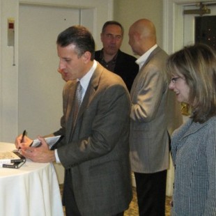 Ed signing a copy of his book.